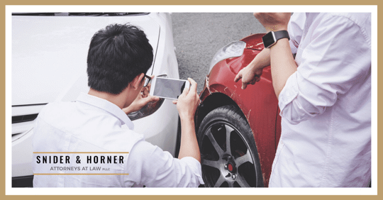 guy taking a picture of an accident